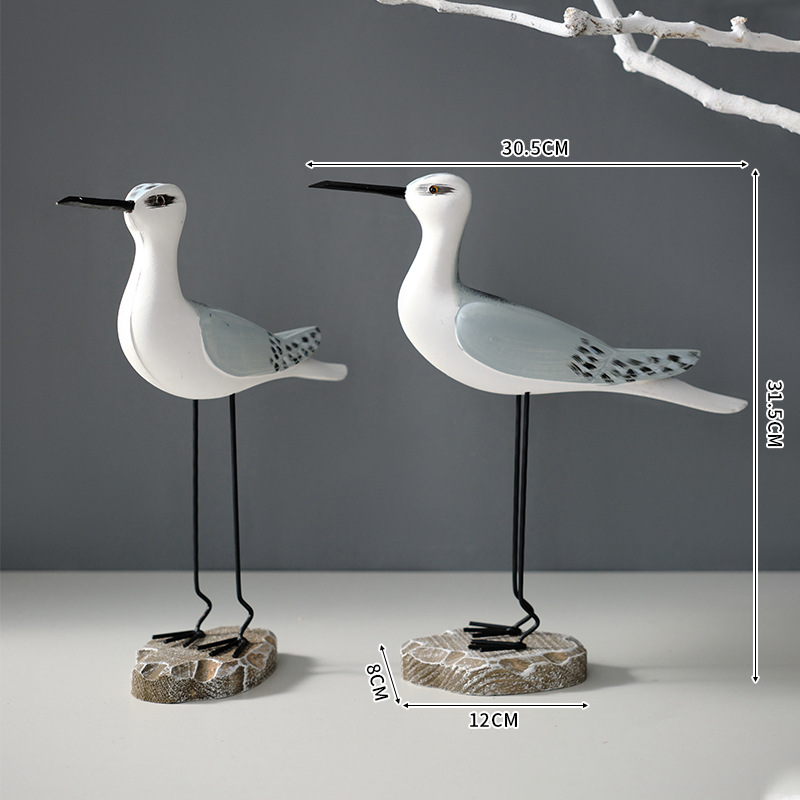A set of gray and white bird ornaments