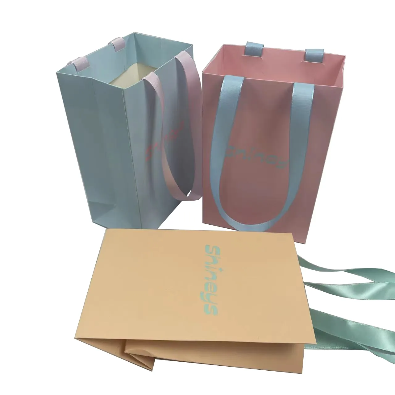 Bolsas de papel de regalo elegantes con logotipo de impresión personalizada, bolsa de compras de papel de boutique de ropa de lujo rosa con asa de cinta