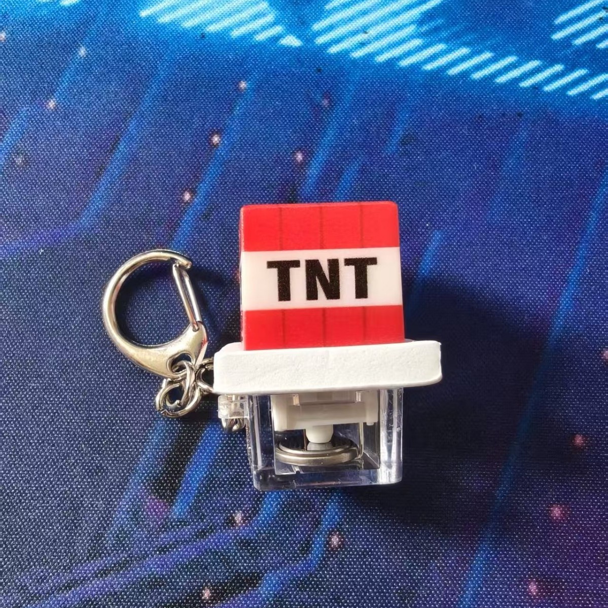 TNT-illuminated button with transparent base