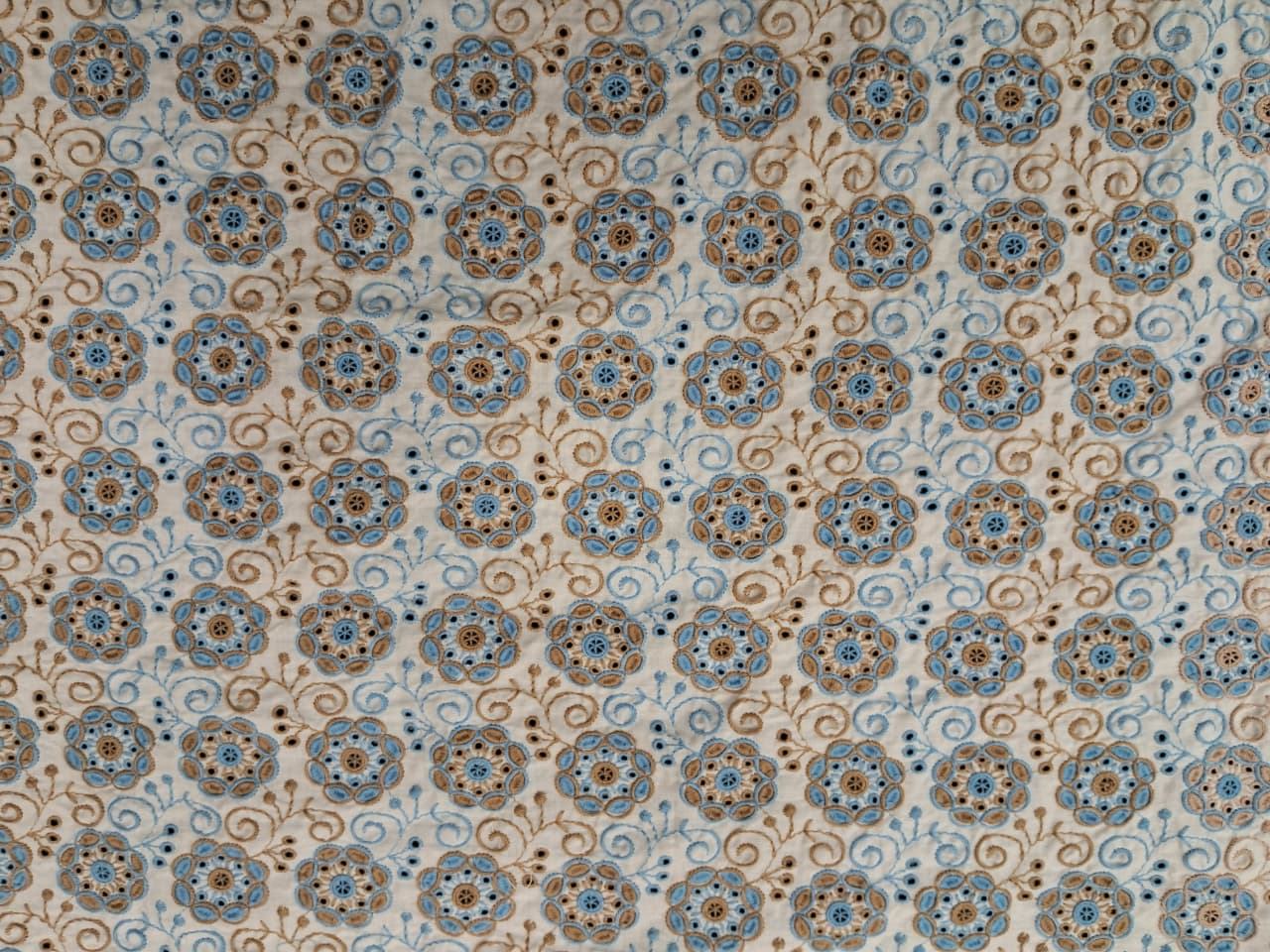 Brown and blue embroidery on white base