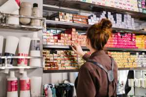 Customer browsing through products on a shelf.