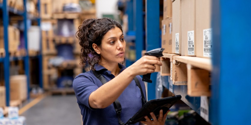 Woman in a warehouse taking inventory