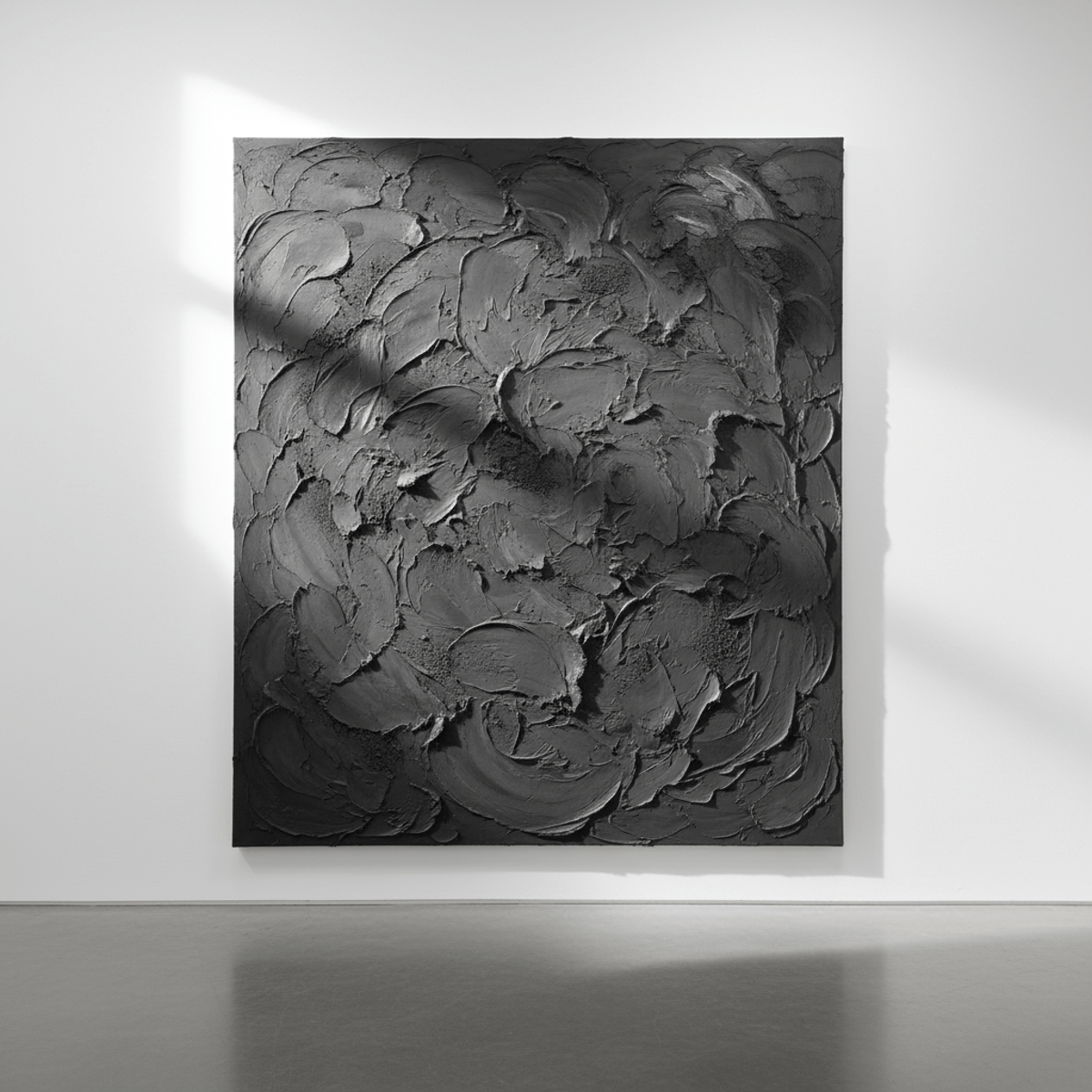 Abstract art canvas with charcoal grey impasto texture, embedded sand, and plaster.
