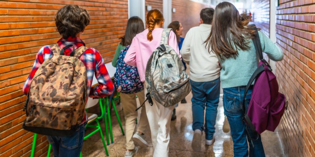 School children wearing backpacks