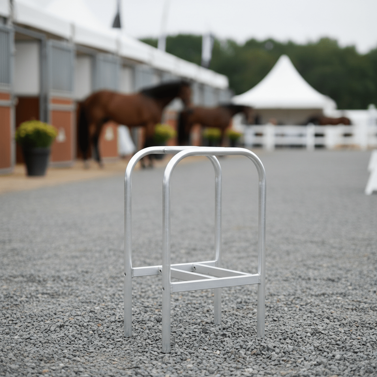 Sleek collapsible saddle rack made of brushed aluminum, folded for transport.