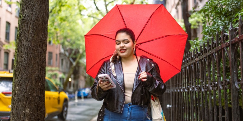 A lady using a red umbrella