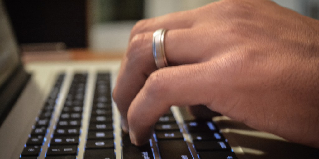 Man with ring using computer