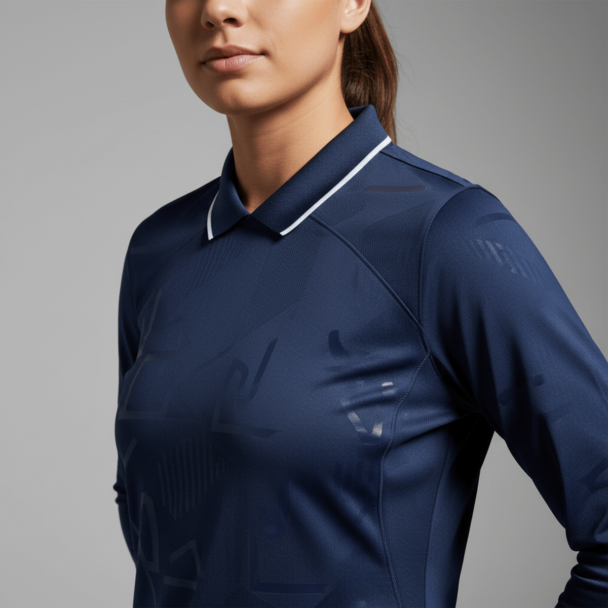 Close-up of a female soccer player's jersey collar with piping and subtle graphic print.