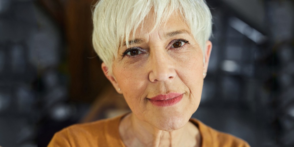 A close view of a senior with blonde pixie hair