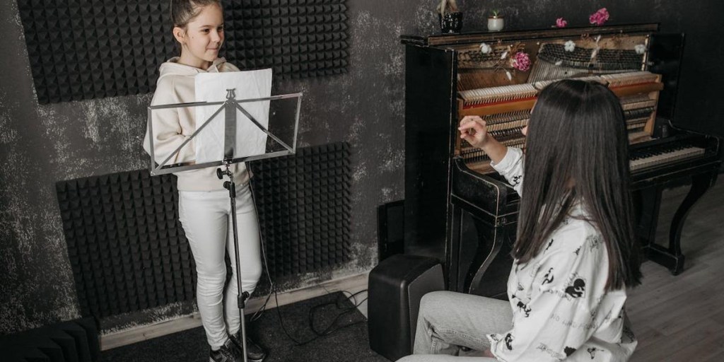 Two musicians in a studio with acoustic foam panel walls