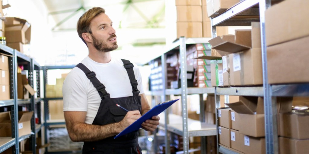 Warehouse worker managing inventory manually