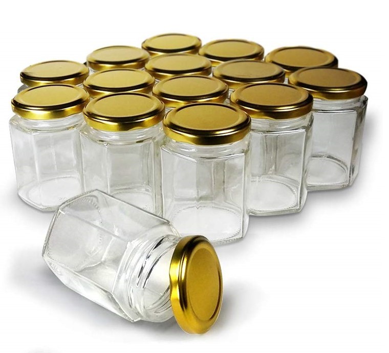 hot selling whole 1000g 730ml 35oz glass bee shaped honey jar glass hexagonal jar for honey package with metal lids