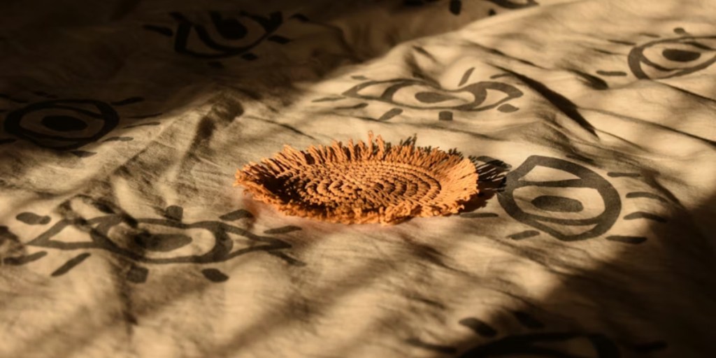 A woven coaster on a patterned surface