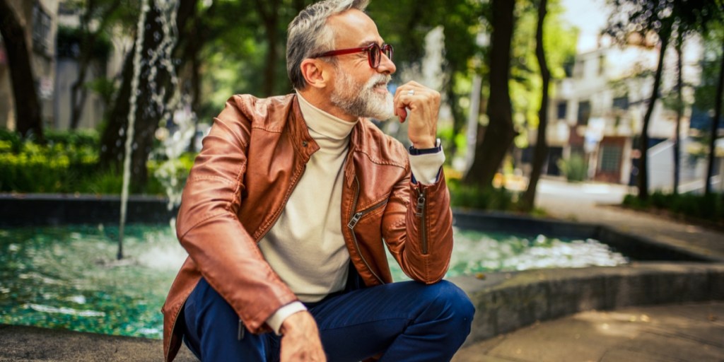 A man wearing a leather jacket and a turtle-neck