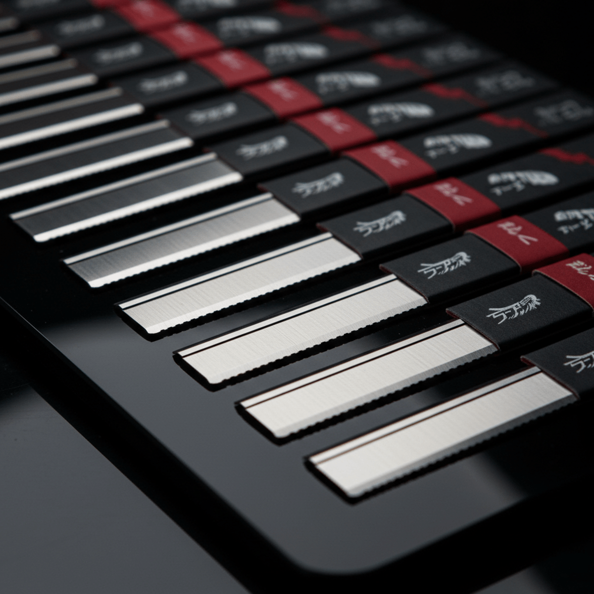 Close-up of ultra-sharp safety razor blades on a glossy black surface.