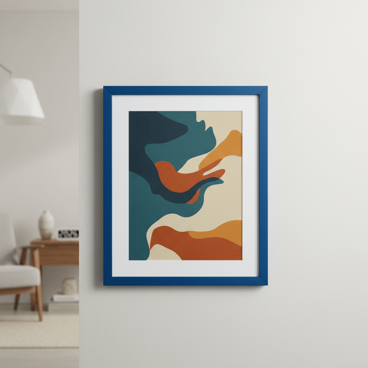 Matte cobalt blue poster frame with abstract art. Cobalt blue aluminum poster frame with abstract art on a blurred living room wall.