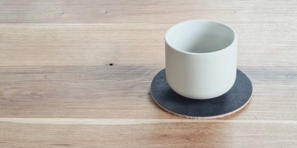 White cup sitting on a silicone coaster