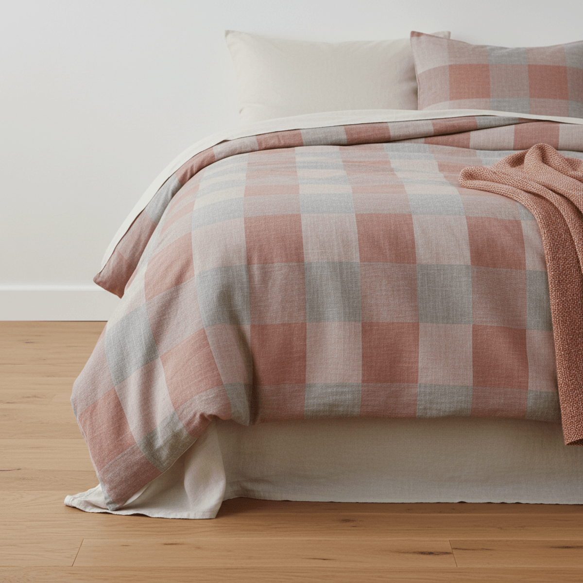 Close-up of a dusty rose and grey checkerboard comforter with woven texture.