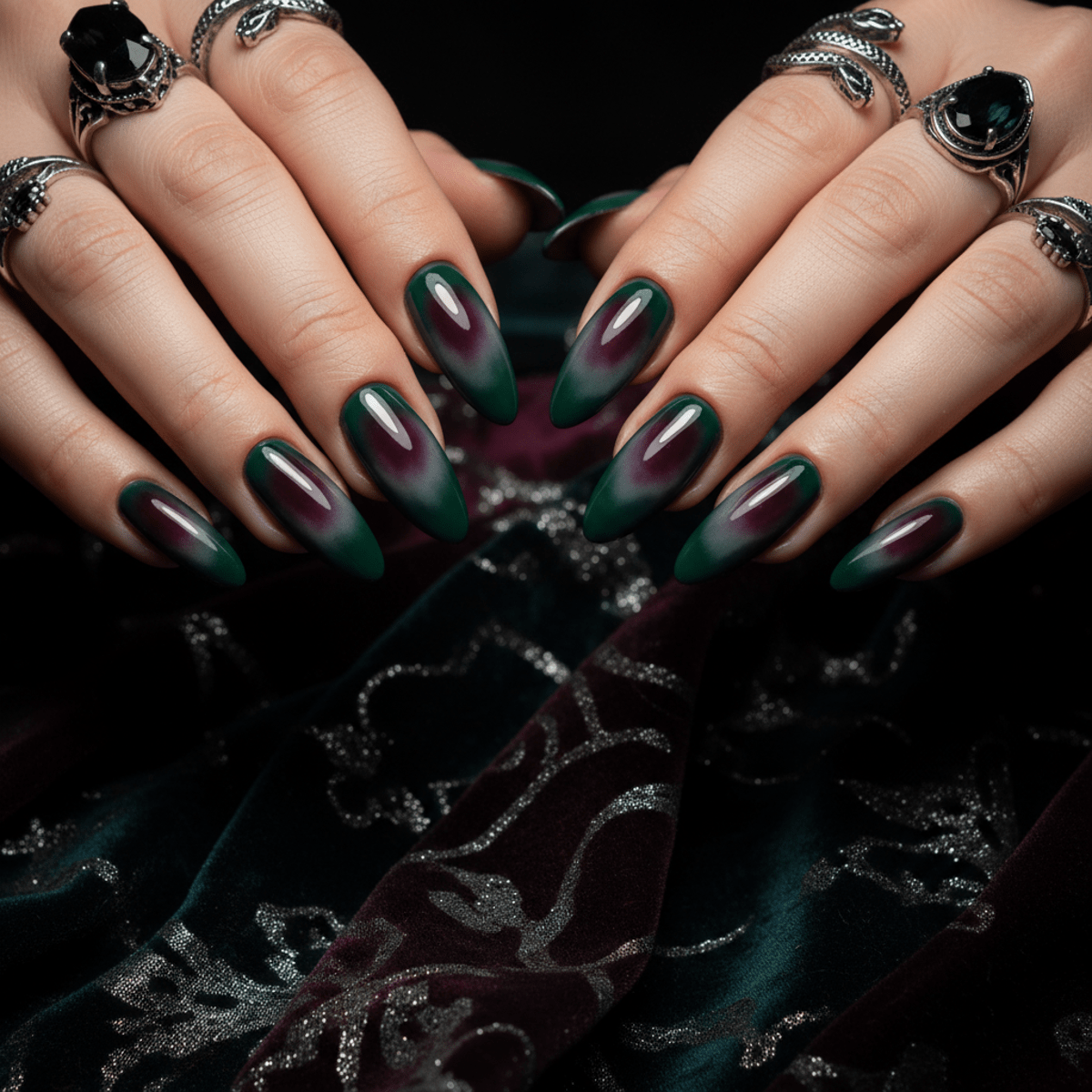 Moody aura nails with forest green blooming from plum, featuring gothic styling.