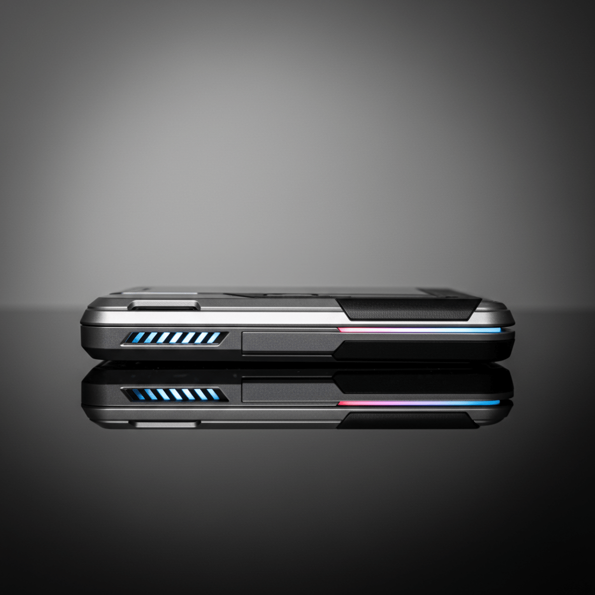 Close-up of a futuristic slider phone in its closed state on a reflective surface.