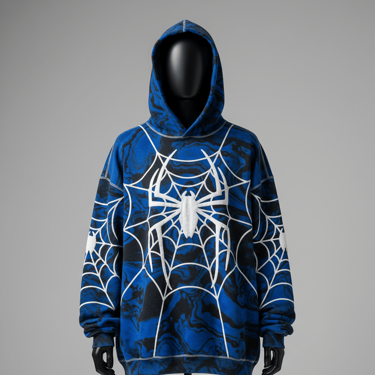 Acid-wash hoodie with electric blue marbled patterns and puff-print spiderwebs on a mannequin.