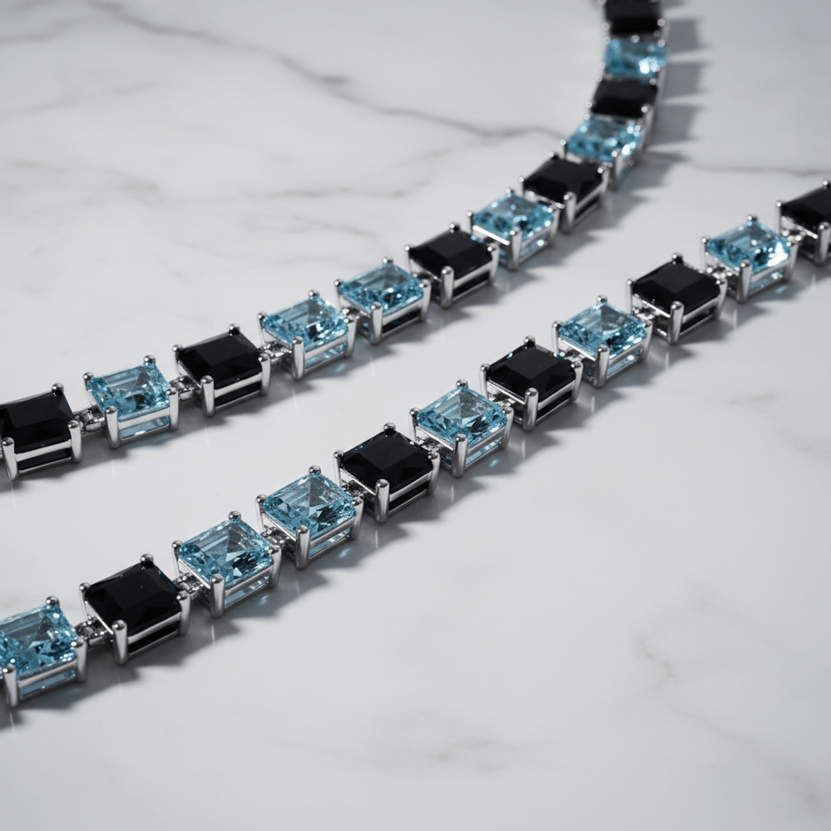 Moissanite diamond chain with blue and black stones on white gold over marble.