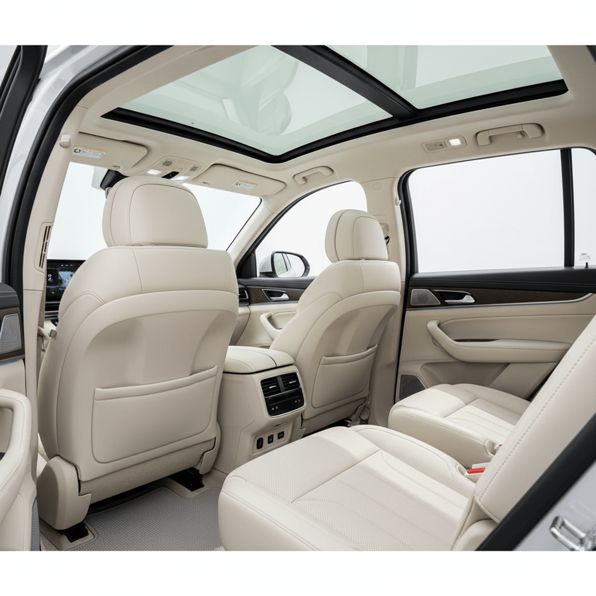 Comfortable third-row SUV seating with sunroof and charging ports. Spacious modern SUV interior with plush third-row seats and panoramic sunroof.