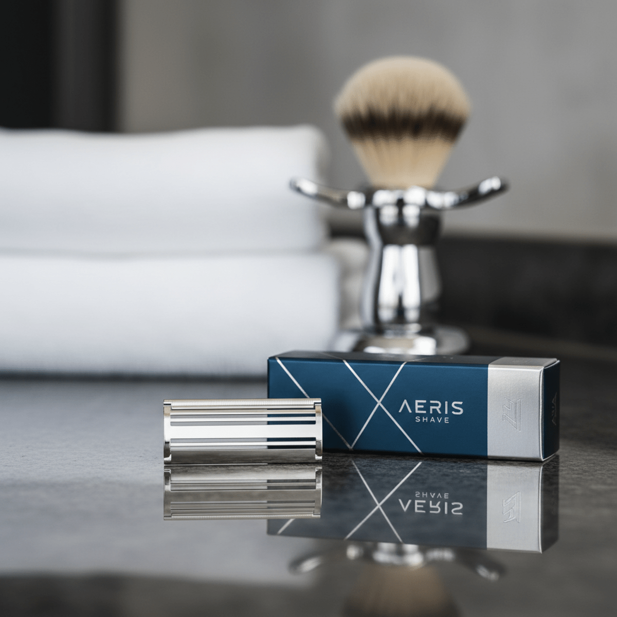 Premium safety razor blade on a glossy counter, with elegant packaging and grooming tools.