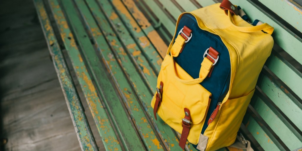 Yellow backpack on a bench