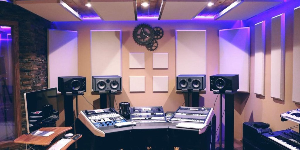 A professional recording studio with acoustic foam panels on walls