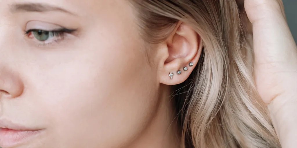 Woman with four stud earrings