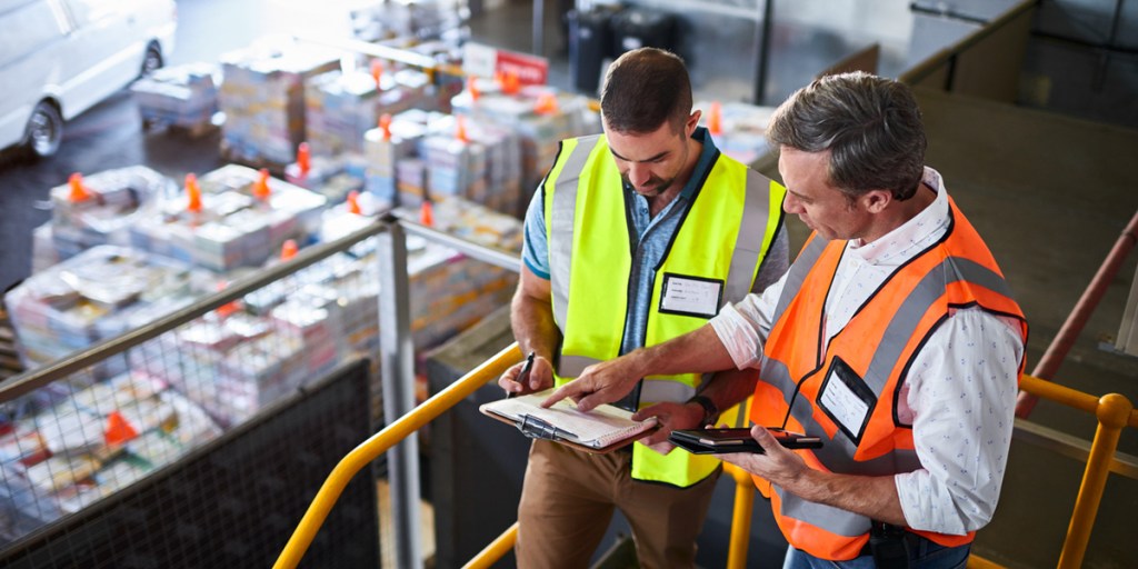 Two warehouse workers standing on stairs