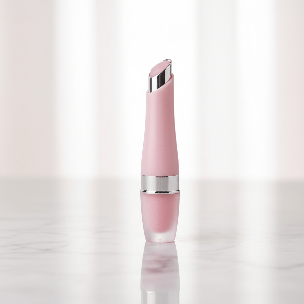 Pink lip balm with metallic zamac applicator tip. Sleek pink lip balm tube with zamac applicator on marble.