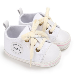 white canvas baby shoes