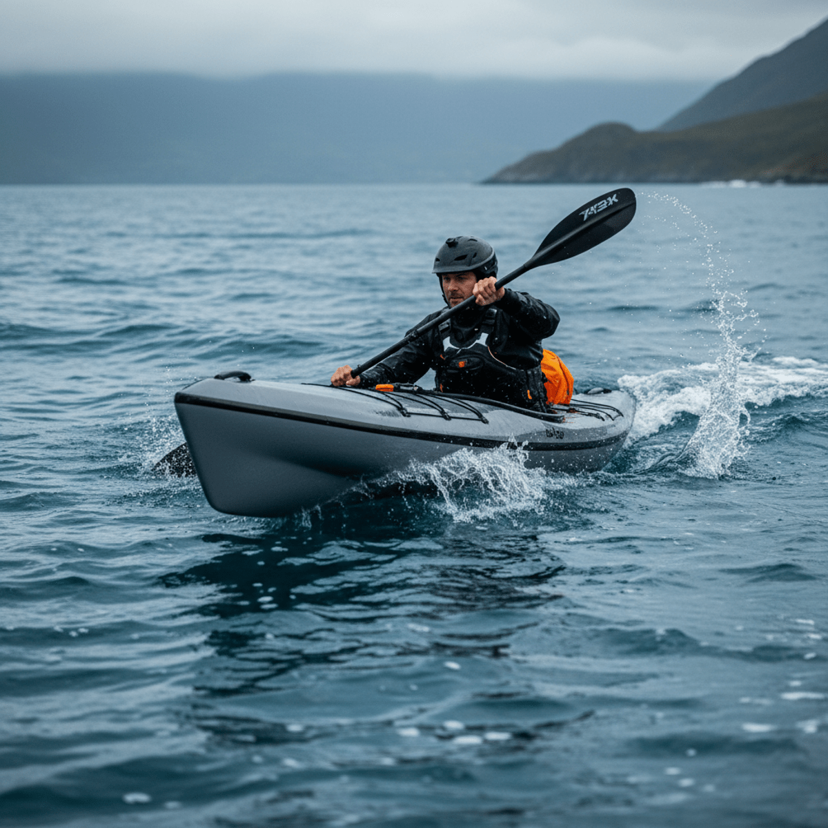 Kayaker in technical gear navigates choppy blue lake on a high-performance portable kayak.