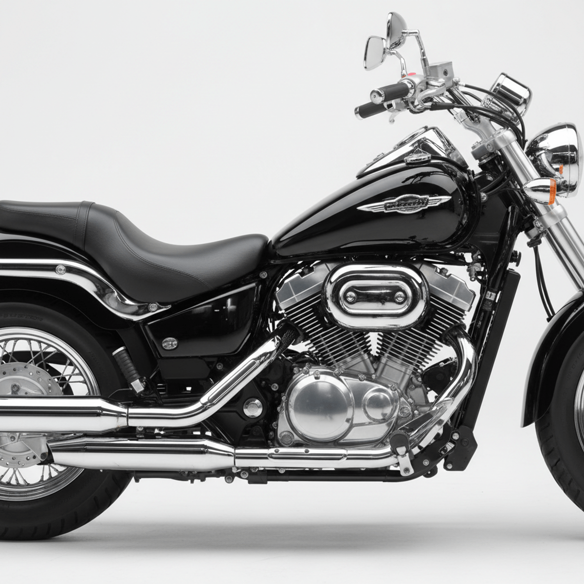 Glossy black cruiser motorcycle with chrome engine. A glossy black cruiser motorcycle with chrome accents in a studio.