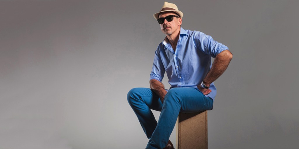 A good-looking 50-year-old man posing with glasses