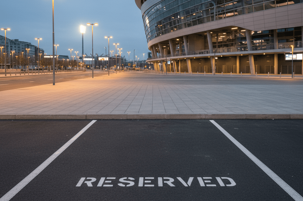 Vacant reserved parking space under streetlights near a stadium, symbolizing high-demand event logistics