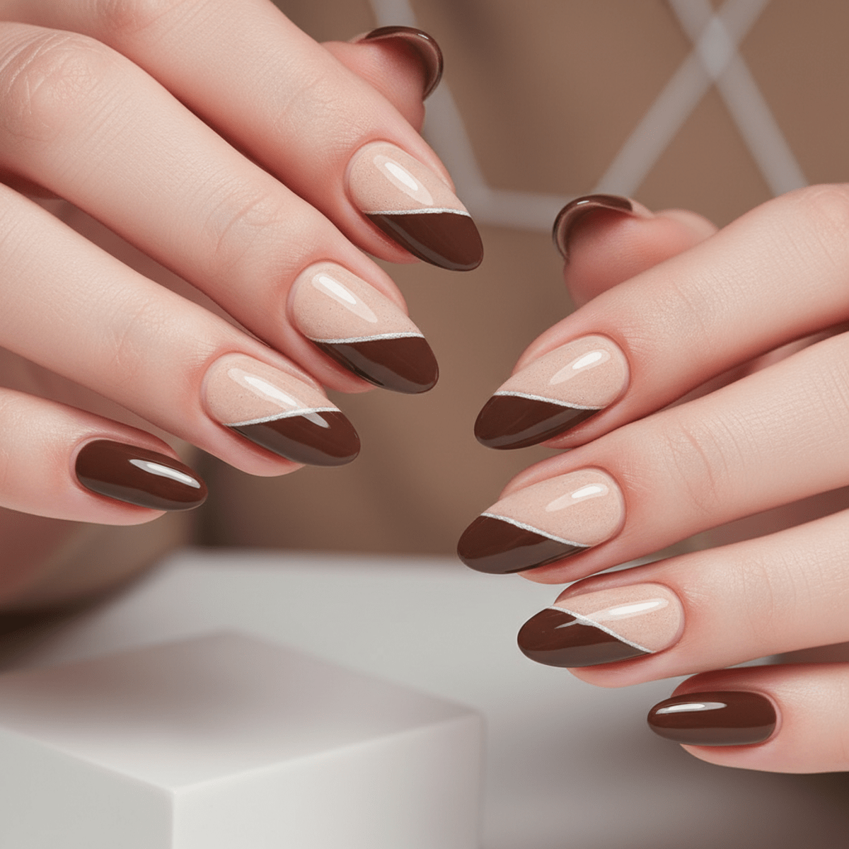 Close-up of mocha mousse nails with creamy beige and coffee brown half & half design.
