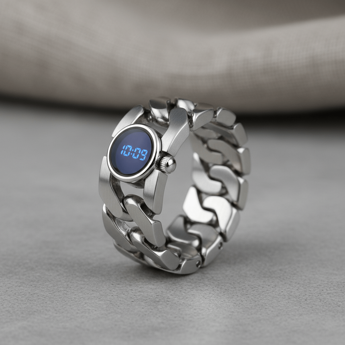 Polished stainless steel ring watch with matte accents and embedded watch face.