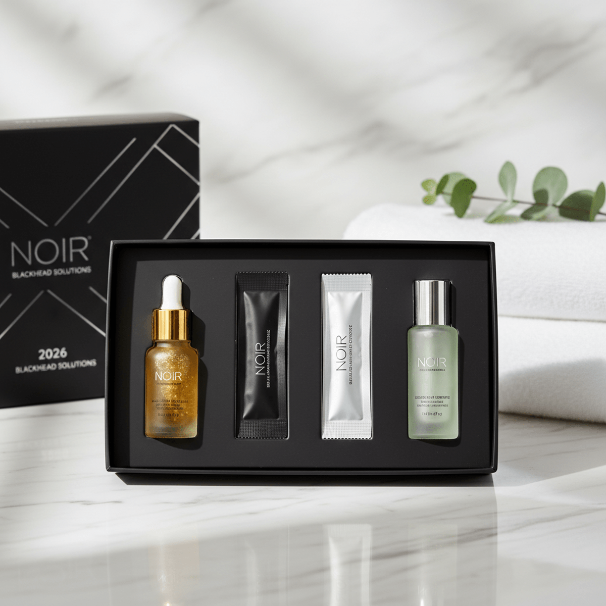 Luxurious nose strip kit with golden essence and cooling serum on marble.