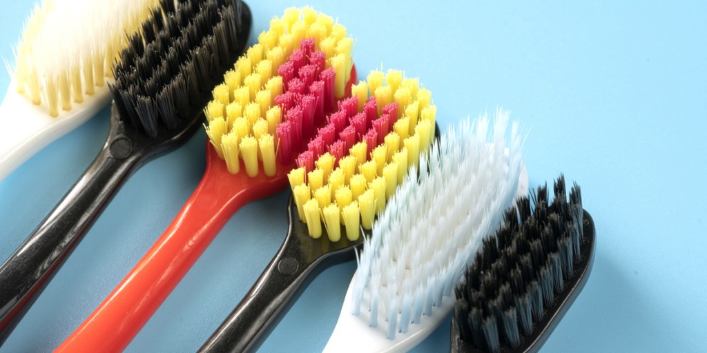 Different set of toothbrushes on a blue background