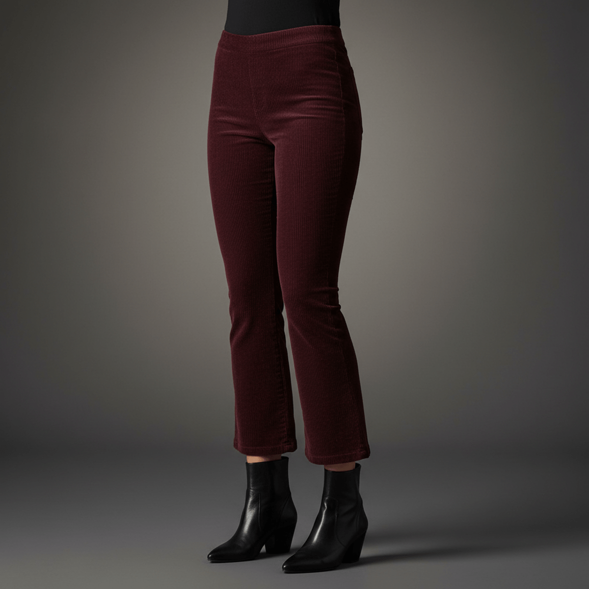 Cropped kick-flare corduroy pants in deep burgundy paired with black ankle boots.