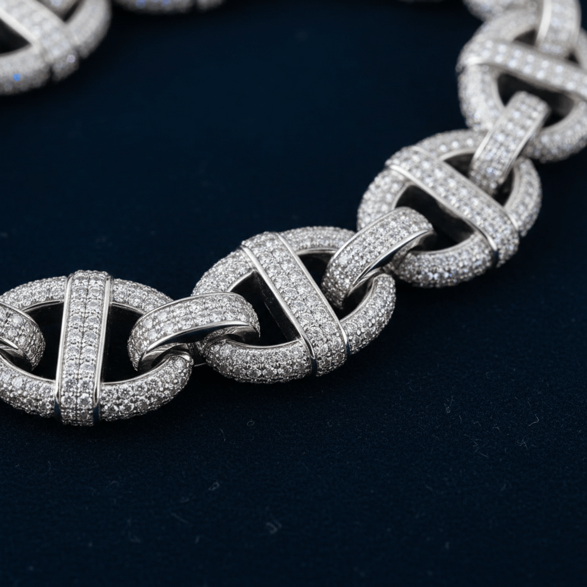 Close-up of a sparkling moissanite mariner link chain with oval links and a silver finish.