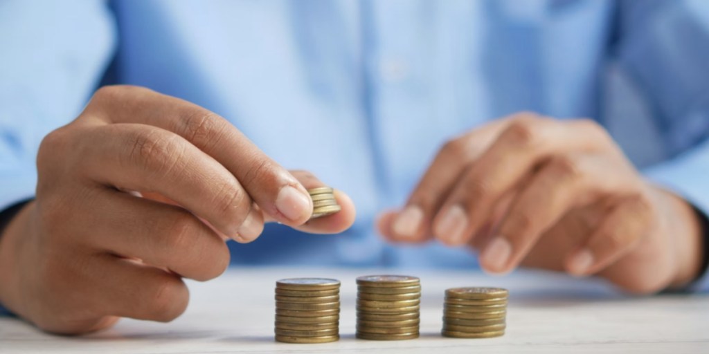 Close up of a person stacking coins