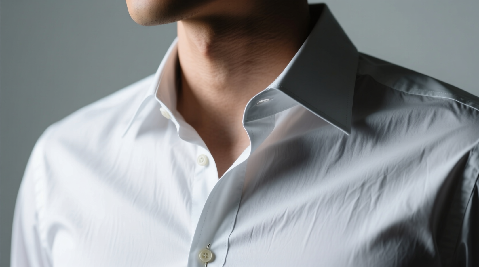 button the top button of a collared shirt before hangin
