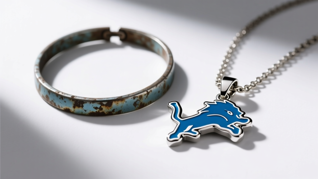 Tarnished zinc alloy sports necklace next to a pristine stainless steel Detroit Lions pendant under bright studio lighting.