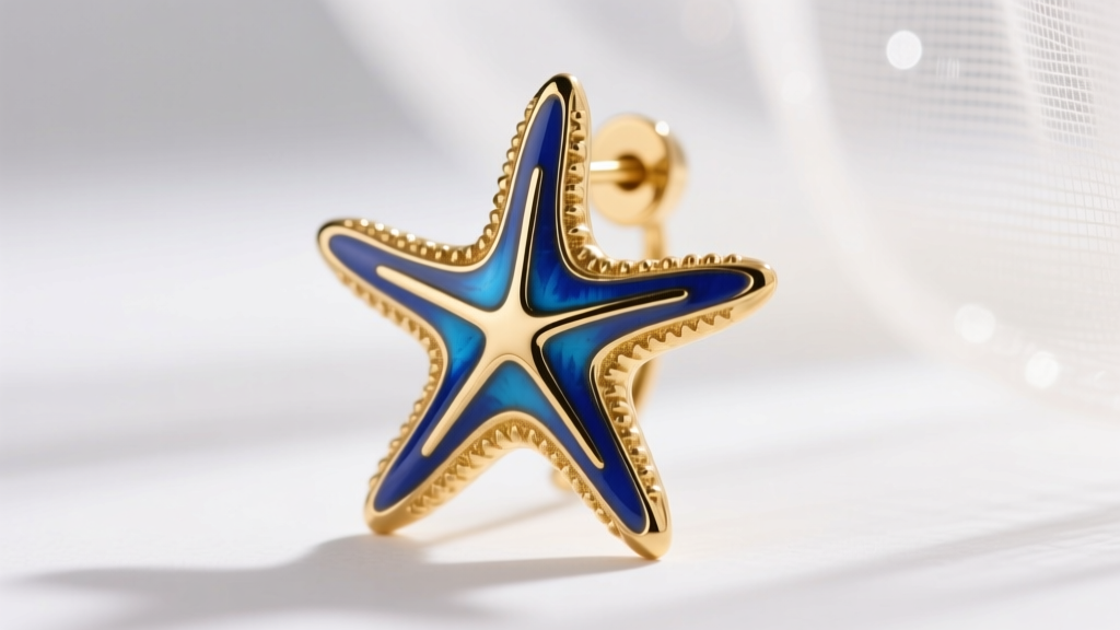 Macro shot of a 14k gold seastar earring with vibrant blue enamel, highlighting the detailed metal texture and glossy finish.