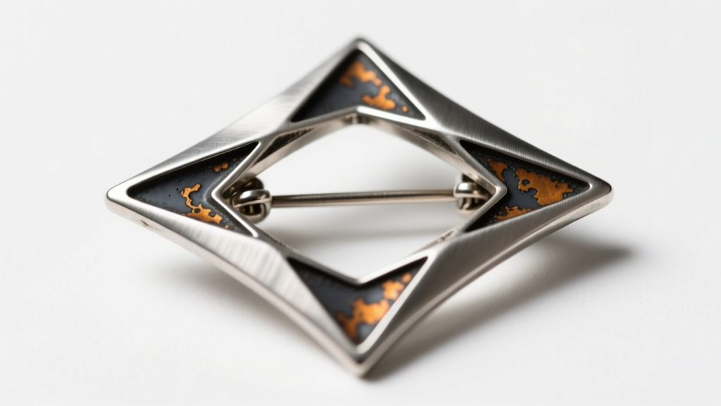 Macro photography of an Ed Wiener atomic age silver brooch showing intentional oxidation and a secure double-pin stem clasp