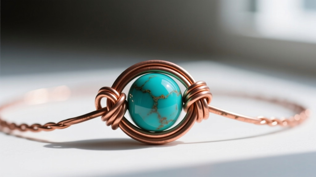 Macro shot of 24-gauge copper wire looped through a turquoise bead to create a secure wire-wrapped link for a boho necklace